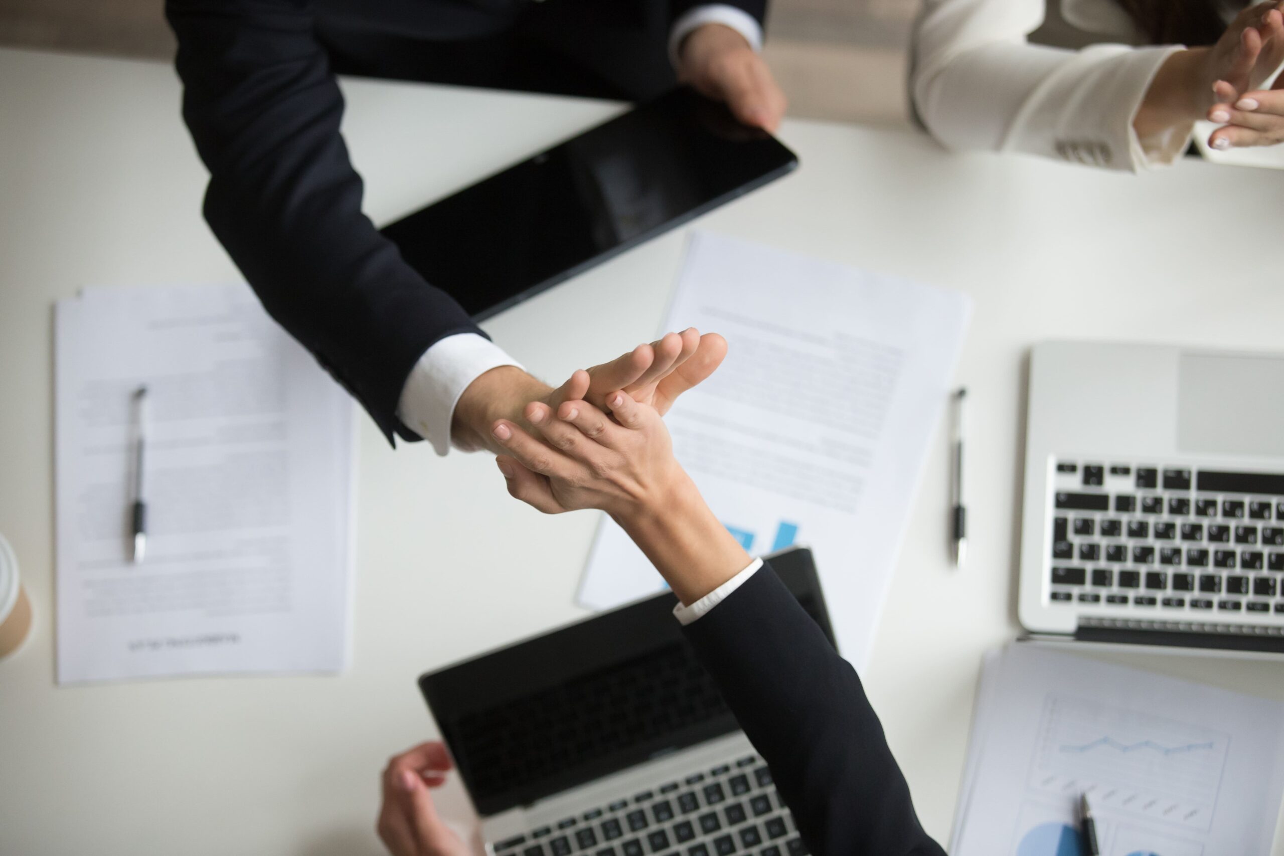 colleagues-giving-high-five-celebrating-good-teamwork-result-top-closeup-view